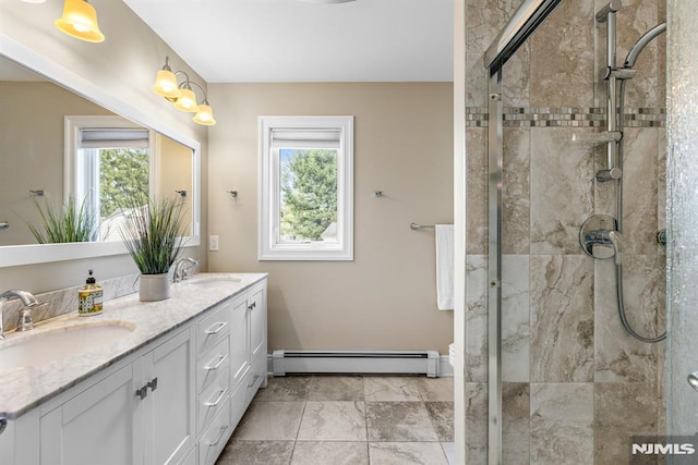 full bath featuring plenty of natural light, a sink, and a baseboard heating unit