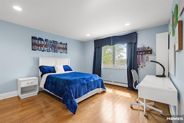bedroom featuring baseboards, a baseboard radiator, recessed lighting, and wood finished floors