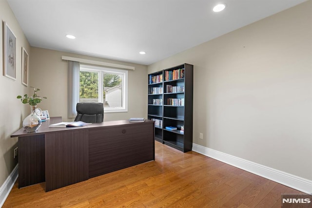 office area featuring recessed lighting, baseboards, and light wood-type flooring