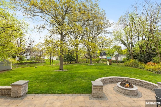 view of yard featuring a patio and a fire pit