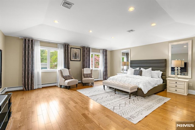 bedroom with visible vents, multiple windows, and light wood finished floors