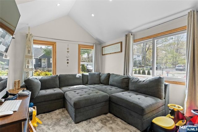 living area featuring lofted ceiling and recessed lighting