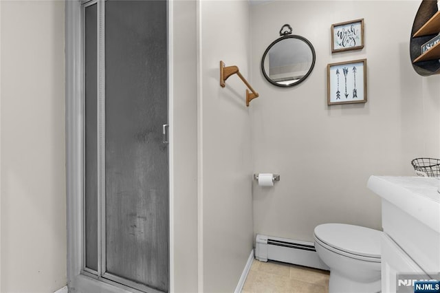 bathroom featuring a shower stall, a baseboard heating unit, baseboards, toilet, and tile patterned flooring