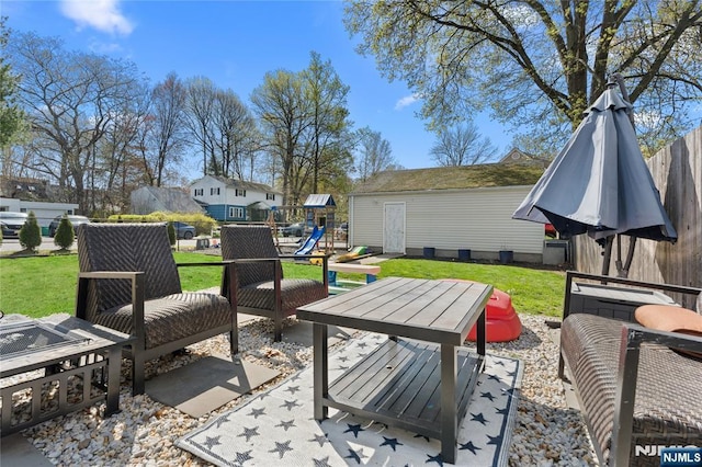 view of patio / terrace featuring fence and a playground