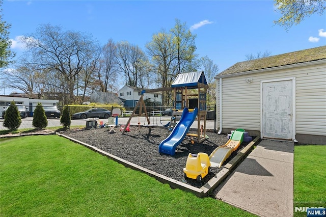 community play area featuring a lawn and fence