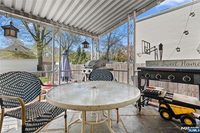 view of patio featuring fence and outdoor dining space
