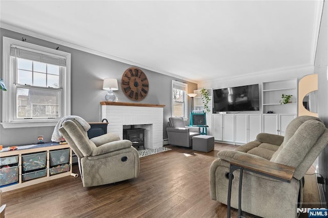 living area with crown molding and wood finished floors