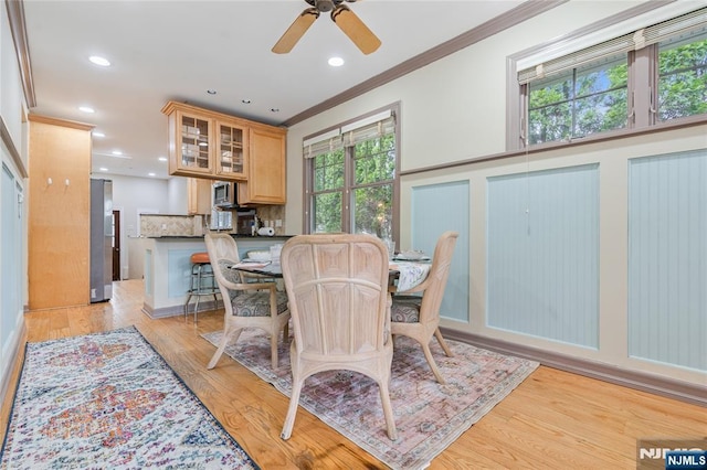 dining space with a wealth of natural light, ornamental molding, and recessed lighting