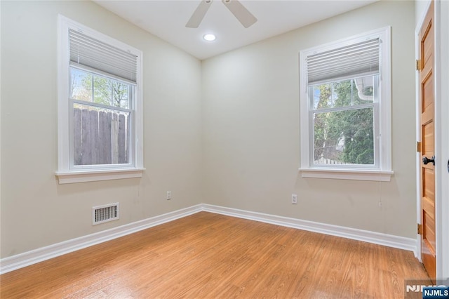 empty room featuring ceiling fan, light wood-style flooring, baseboards, visible vents, and recessed lighting