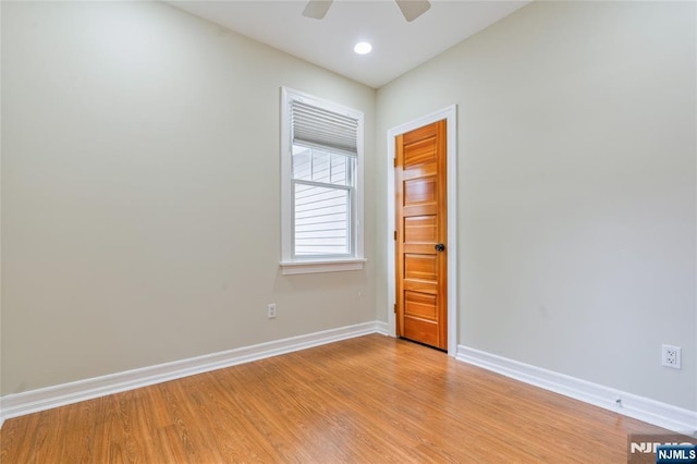 spare room featuring baseboards, a ceiling fan, light wood finished floors, and recessed lighting