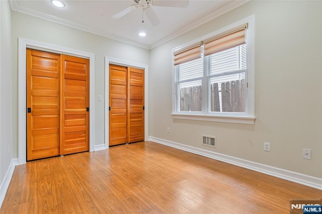 unfurnished bedroom with recessed lighting, light wood finished floors, visible vents, crown molding, and baseboards