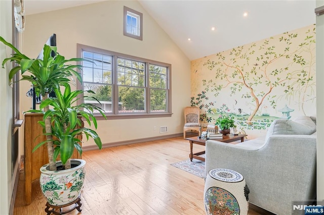 sitting room with baseboards, recessed lighting, wallpapered walls, wood finished floors, and high vaulted ceiling