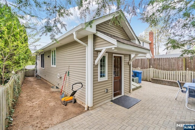 view of outbuilding featuring a fenced backyard and central AC
