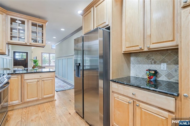 kitchen with light brown cabinets, glass insert cabinets, stainless steel appliances, and light wood-style flooring