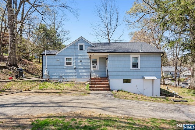 back of property featuring a shingled roof