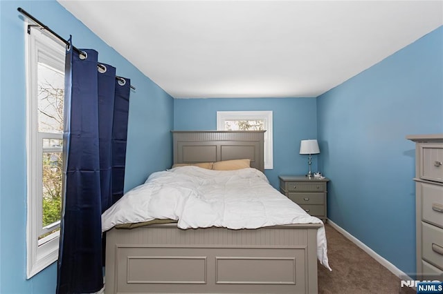 bedroom featuring carpet and baseboards