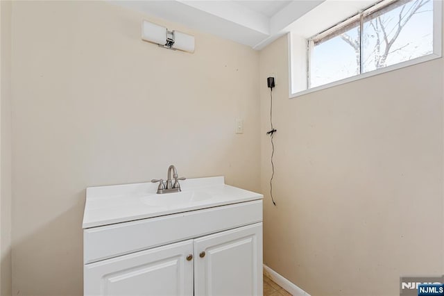 bathroom with vanity and baseboards
