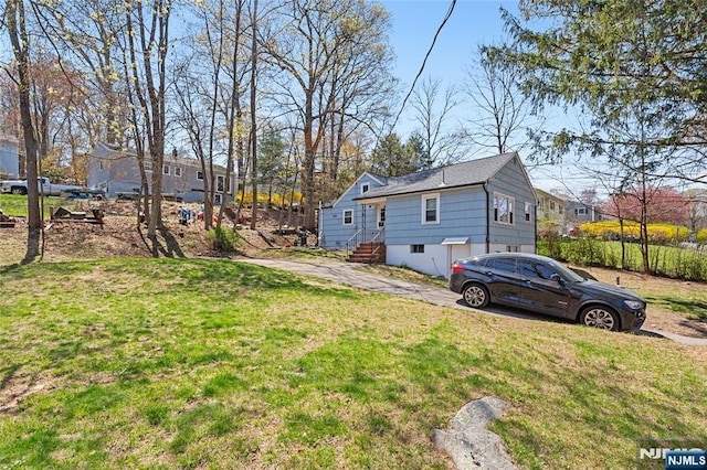 view of property exterior with a yard
