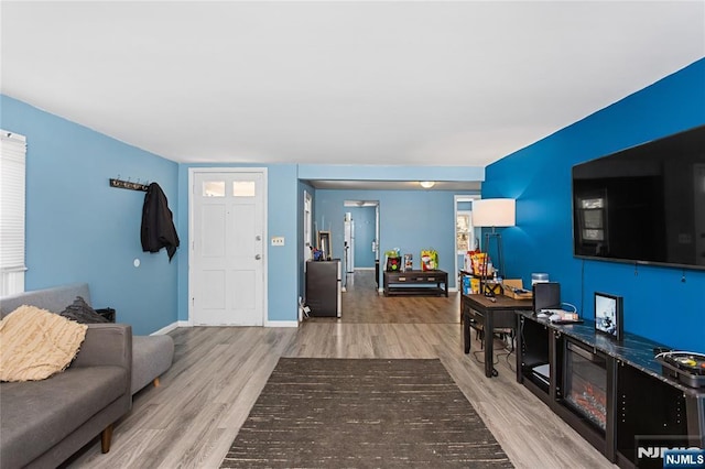 living room featuring wood finished floors and baseboards