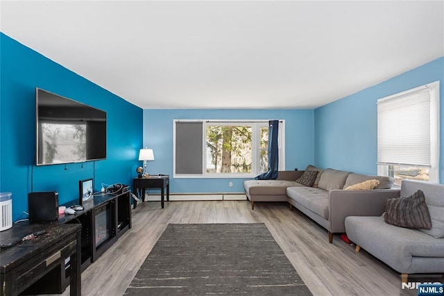 living area with baseboard heating and wood finished floors