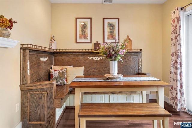 dining area with wood finished floors, visible vents, and baseboards