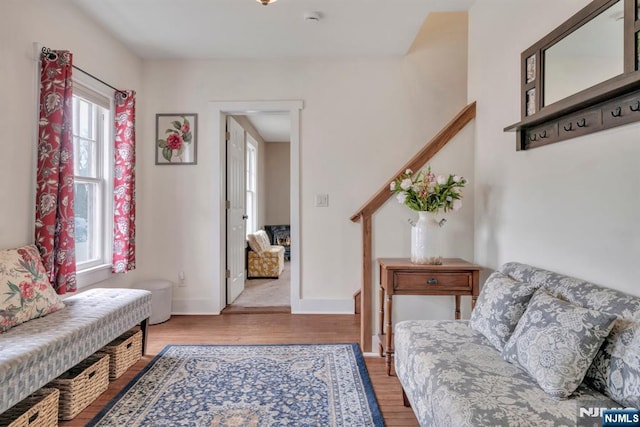 interior space featuring baseboards, light wood-type flooring, and stairway
