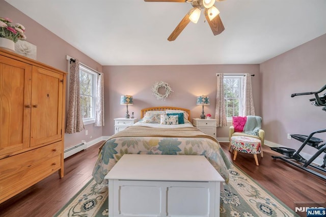 bedroom featuring baseboards, multiple windows, dark wood-type flooring, and a baseboard radiator