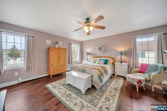 bedroom featuring a ceiling fan, baseboard heating, wood finished floors, and a baseboard radiator