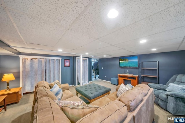 carpeted living area with baseboards, recessed lighting, and a drop ceiling