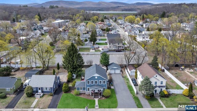 birds eye view of property featuring a mountain view and a residential view