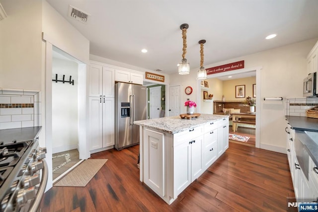 kitchen with white cabinetry, visible vents, stainless steel appliances, a kitchen island, and recessed lighting