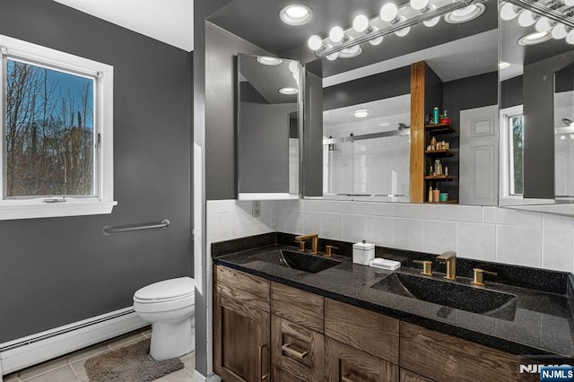 bathroom featuring a baseboard radiator, toilet, a sink, and a stall shower