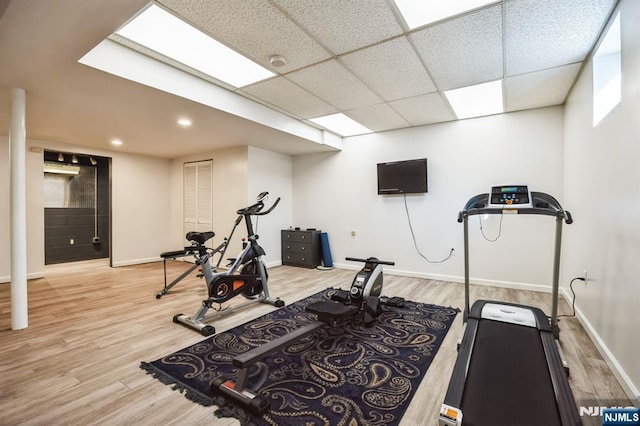 workout room with wood finished floors and baseboards