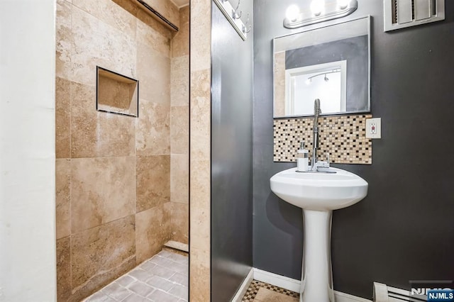 bathroom featuring baseboard heating and a tile shower
