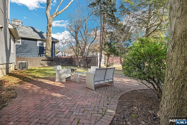 view of patio featuring an outdoor hangout area, central AC, and a fenced backyard