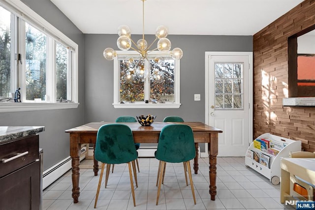 dining room with a baseboard heating unit, a chandelier, and light tile patterned floors