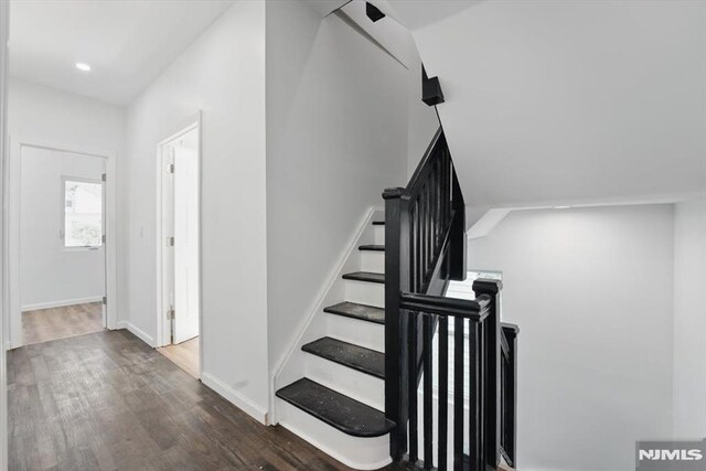 stairs featuring recessed lighting, wood finished floors, and baseboards