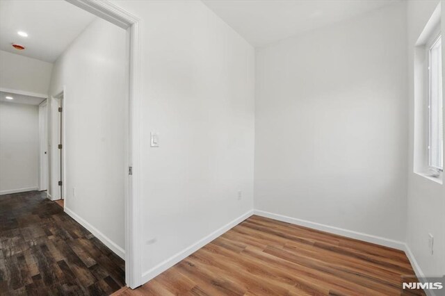 interior space with recessed lighting, wood finished floors, a wealth of natural light, and baseboards