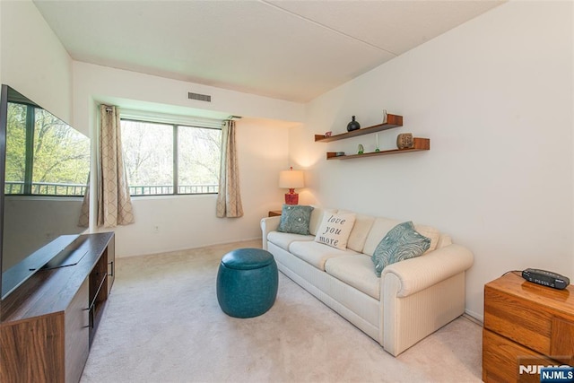 living room with light carpet and visible vents