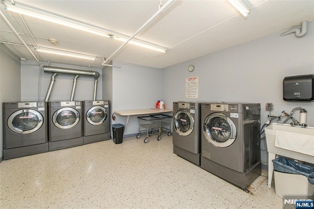 shared laundry area featuring baseboards and separate washer and dryer