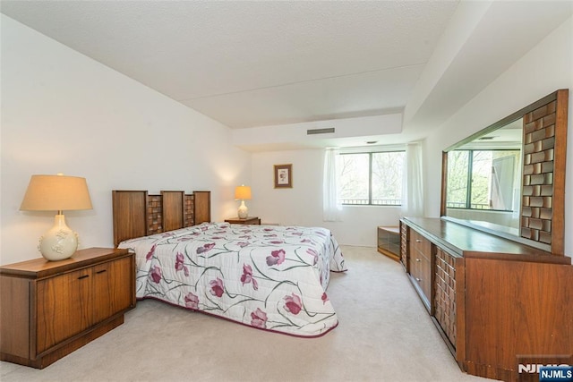 bedroom with light colored carpet and visible vents