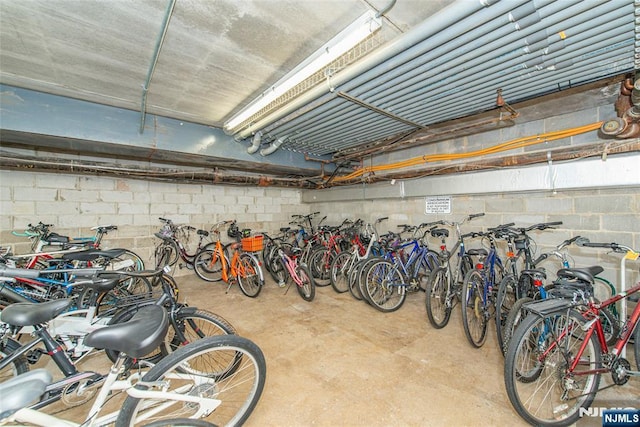 garage featuring concrete block wall and bike storage