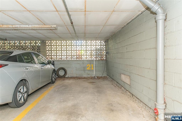 parking garage featuring concrete block wall