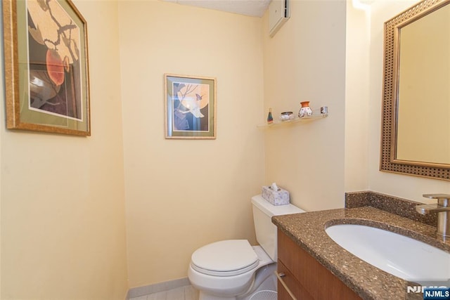 half bath featuring toilet and vanity