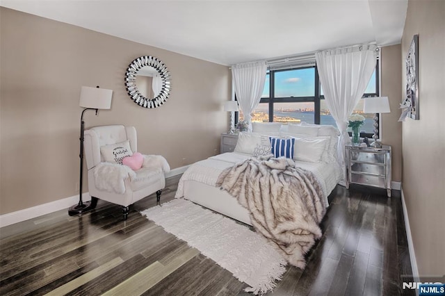 bedroom featuring baseboards and wood finished floors