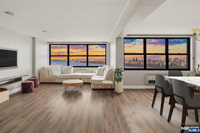 living area featuring wood finished floors, baseboards, and a water view