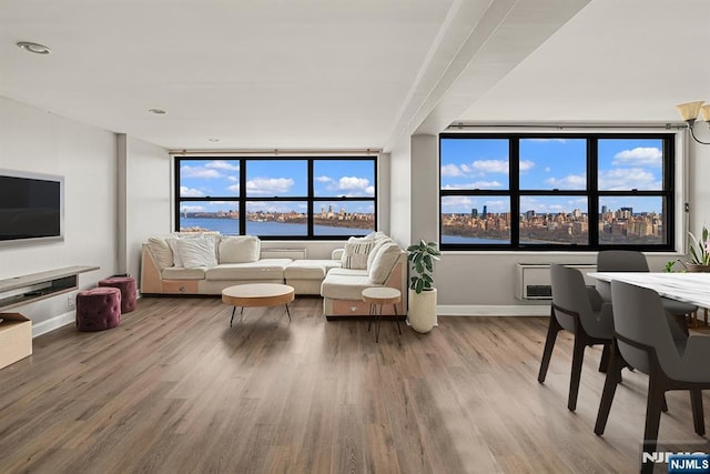living area featuring wood finished floors, baseboards, and a water view