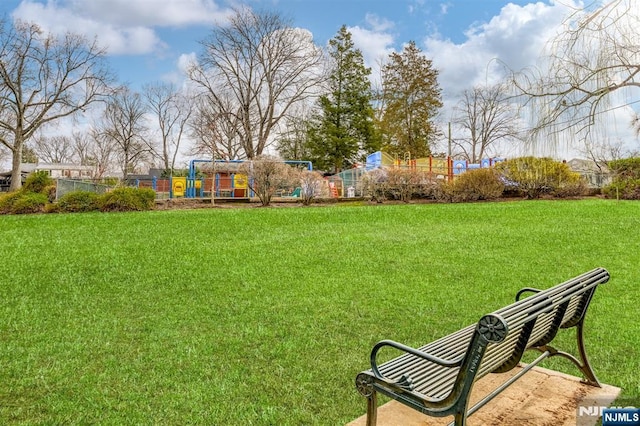 view of yard featuring fence and playground community