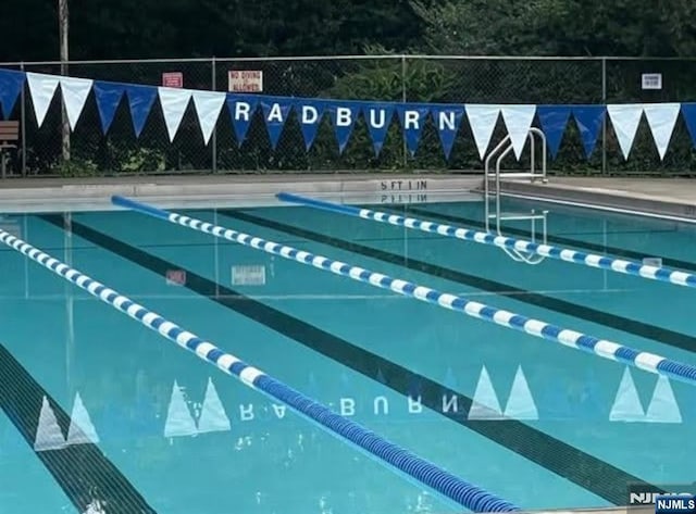 view of swimming pool with fence
