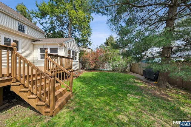 view of yard with a fenced backyard, stairs, and a deck
